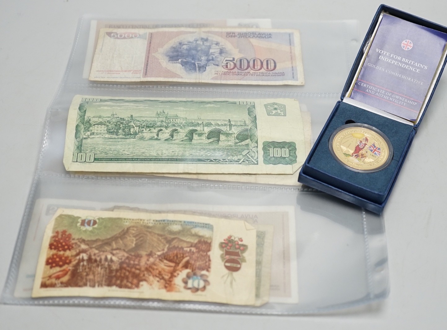A box of UK and world coins and banknotes, a masonic steel fob seal and a Victorian brass belt buckle